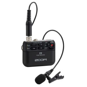 Compact Zoom F2 field recorder with lavalier mic attached on a plain background.